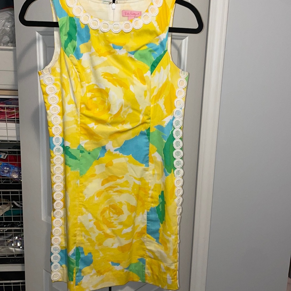 Yellow floral dress with white lace edging.